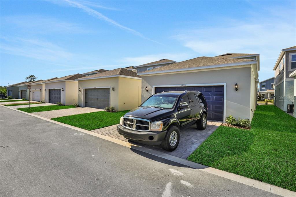 13037 Serene Glade Road Winter Garden, FL 34787 - Photo 7 of 62 a car parked in front of house with a yard