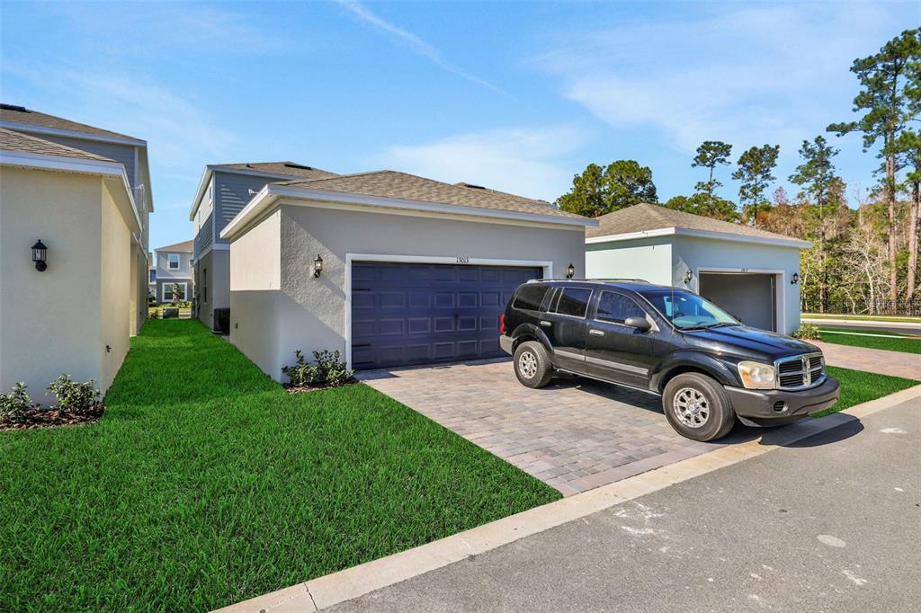 13037 Serene Glade Road Winter Garden, FL 34787 - Photo 8 of 62 a car parked in front of white house