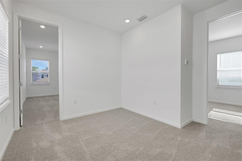 13037 Serene Glade Road Winter Garden, FL 34787 - Photo 10 of 62 an empty room with windows and entrance to other room