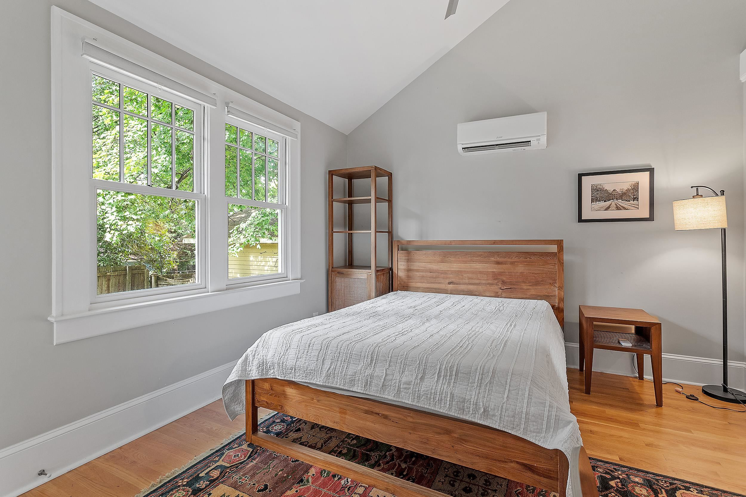 527 Euclid Street Raleigh, NC 27604 - Photo 25 of 27 a bedroom with a bed a table and a window