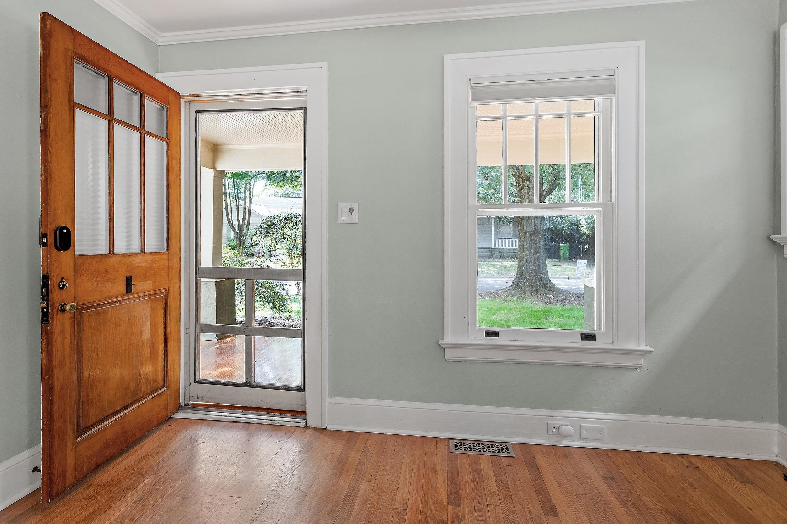 527 Euclid Street Raleigh, NC 27604 - Photo 4 of 27 an empty room with wooden floor and windows