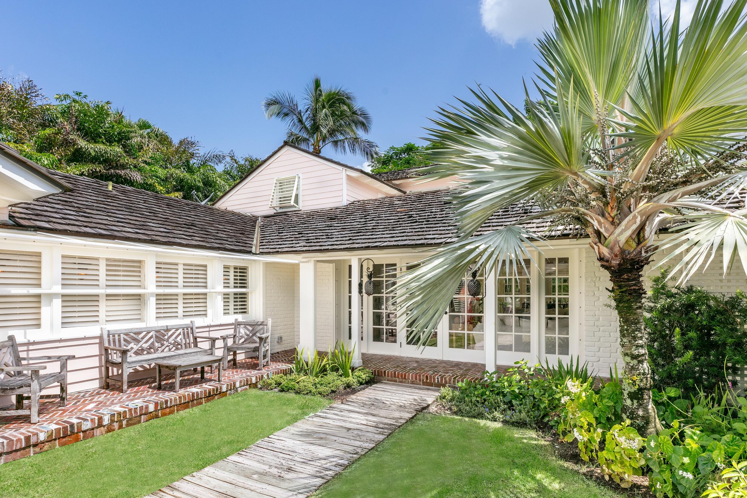 a front view of a house with a yard table and chairs