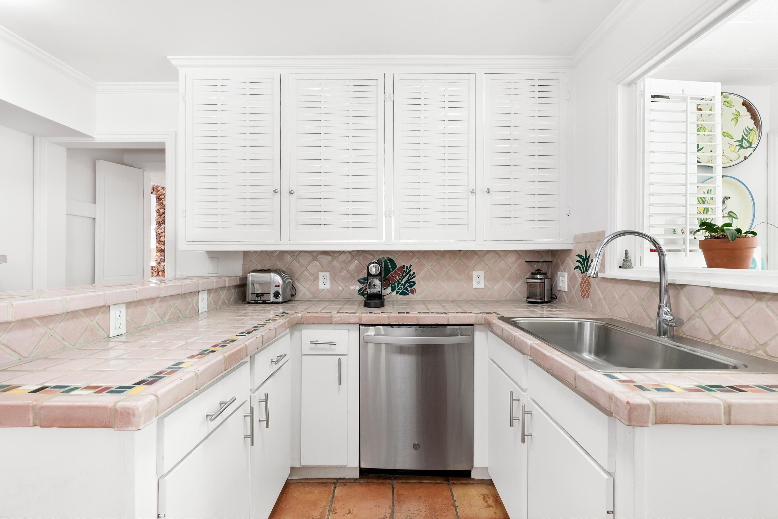 285 Orange Grove Road Palm Beach, FL 33480 - Photo 16 of 29 a kitchen with a sink cabinets and window