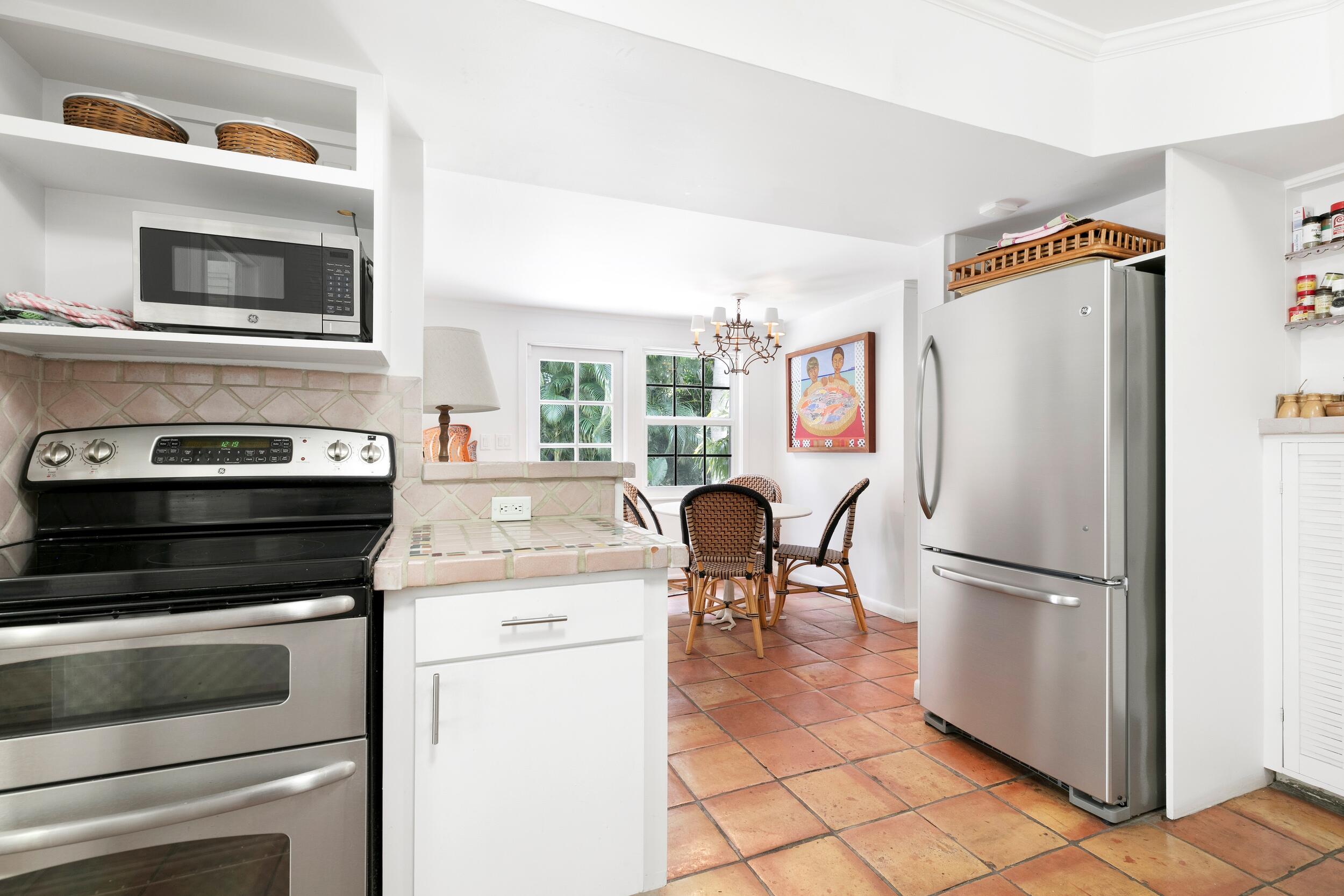 285 Orange Grove Road Palm Beach, FL 33480 - Photo 17 of 29 a kitchen with granite countertop a refrigerator stove and sink