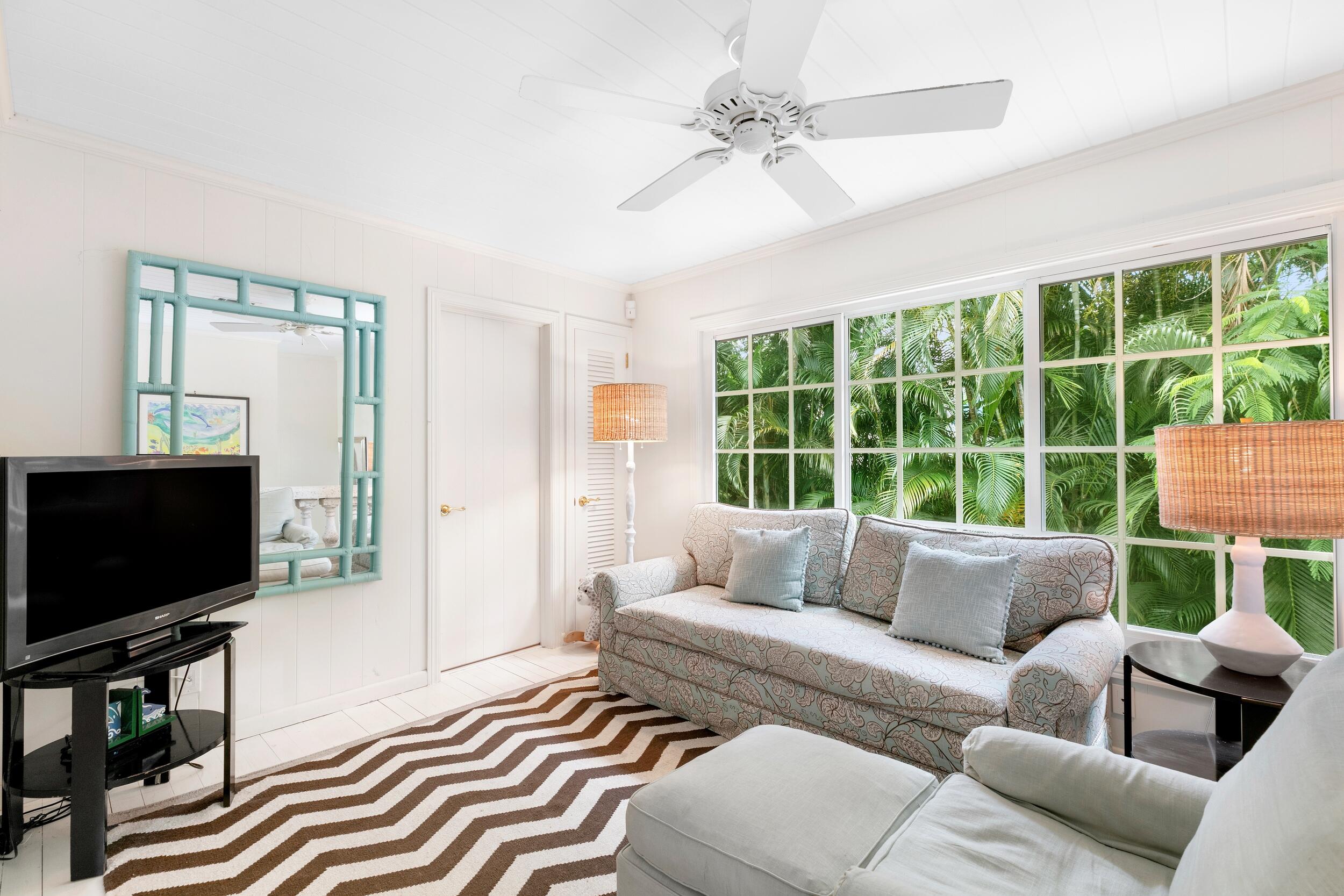 285 Orange Grove Road Palm Beach, FL 33480 - Photo 25 of 29 a living room with furniture and a flat screen tv