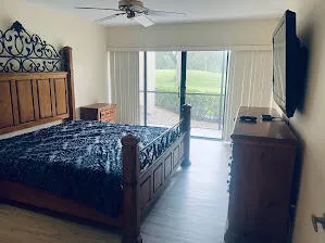 a bedroom with a bed a flat screen tv and a telescope