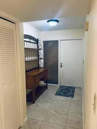 a view of kitchen with windows and entryway