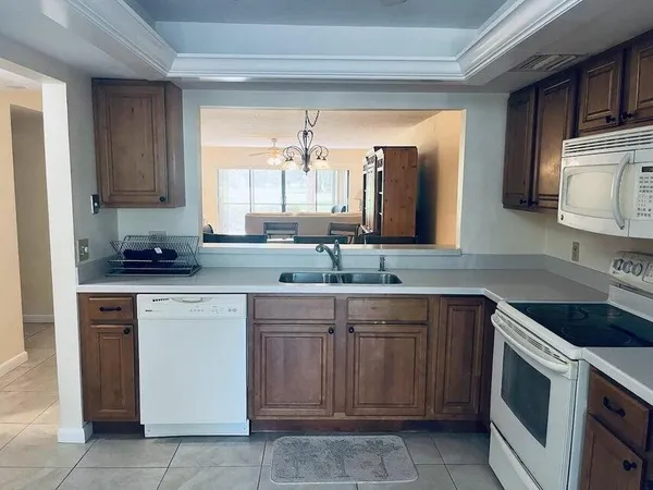 a kitchen with a sink stove and cabinets