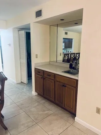 a spacious bathroom with a granite countertop sink and a mirror