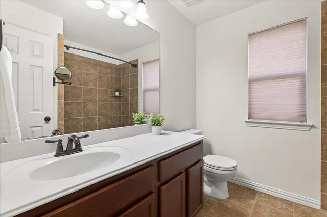 an empty room with a ceiling fan and wooden floor