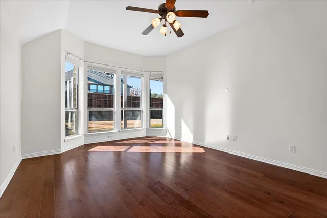 a large white bathroom with a sink mirror and tub