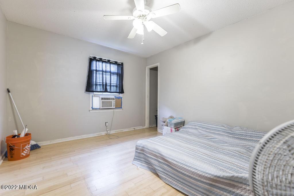115 Coley Lake Road Macon, GA 31216 - Photo 25 of 42 a bedroom with a bed and a chandelier