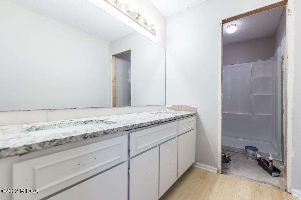 115 Coley Lake Road Macon, GA 31216 - Photo 28 of 42 a bathroom with a granite countertop sink and a mirror