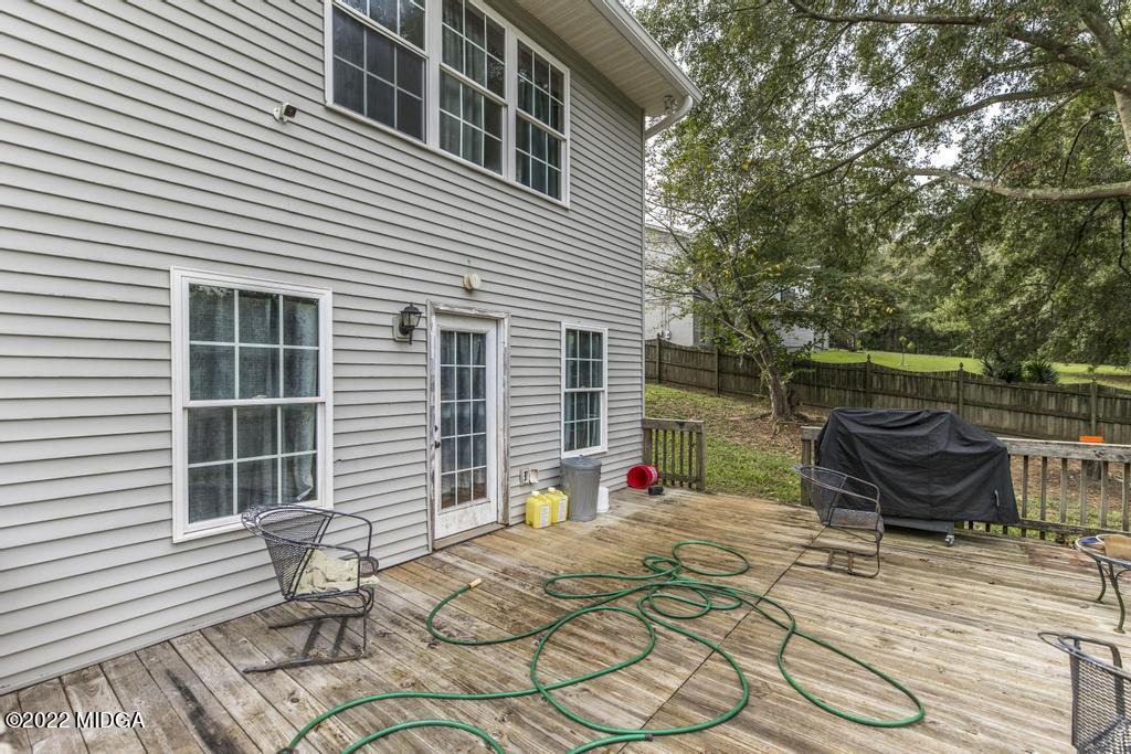 115 Coley Lake Road Macon, GA 31216 - Photo 35 of 42 a view of a patio with a table and chairs and wooden floor