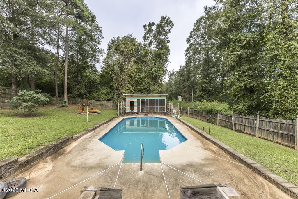 115 Coley Lake Road Macon, GA 31216 - Photo 37 of 42 a view of a backyard with a garden and trees