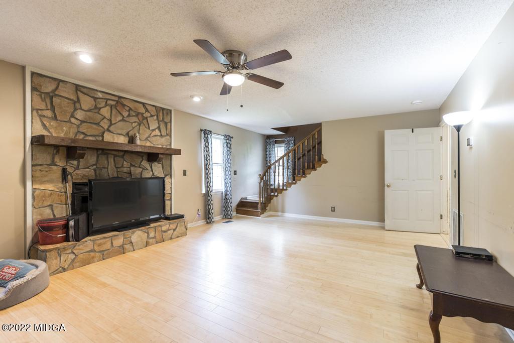 115 Coley Lake Road Macon, GA 31216 - Photo 6 of 42 a view of a livingroom with wooden floor and a ceiling fan