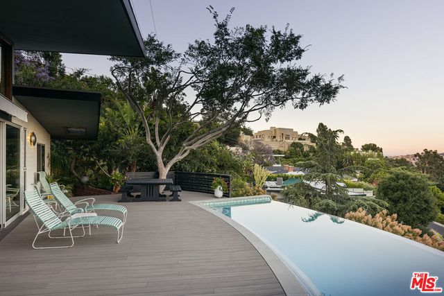 a view of a terrace with yard and mountain view