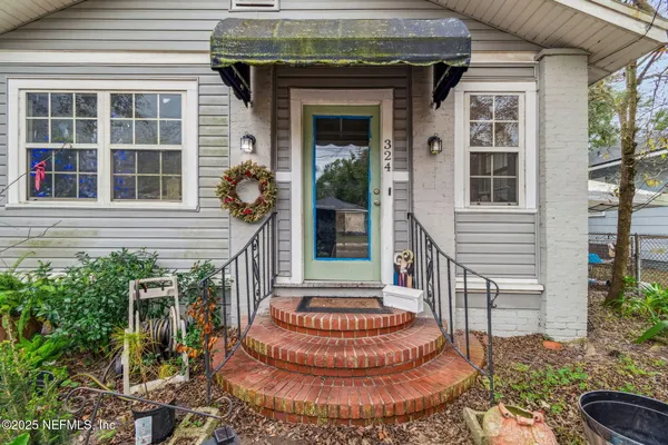 a front view of a house with a garden