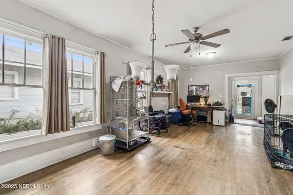a view of a livingroom with lounge chair and a large window