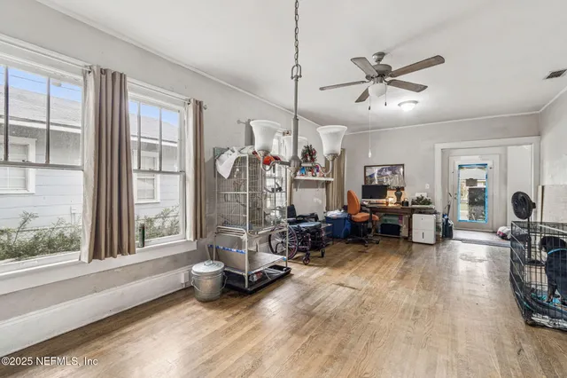 a view of a livingroom with lounge chair and a large window
