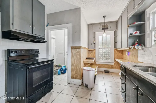 a kitchen with a stove and a refrigerator