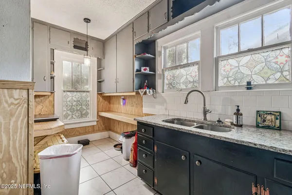 a kitchen with stainless steel appliances granite countertop a sink and cabinets