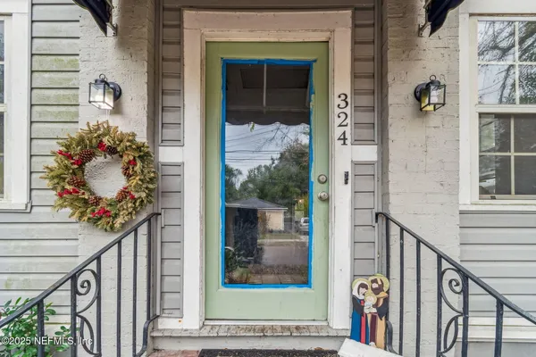 a view of a hallway with wooden floor and a potted plant