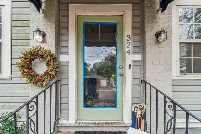 a view of a hallway with wooden floor and a potted plant