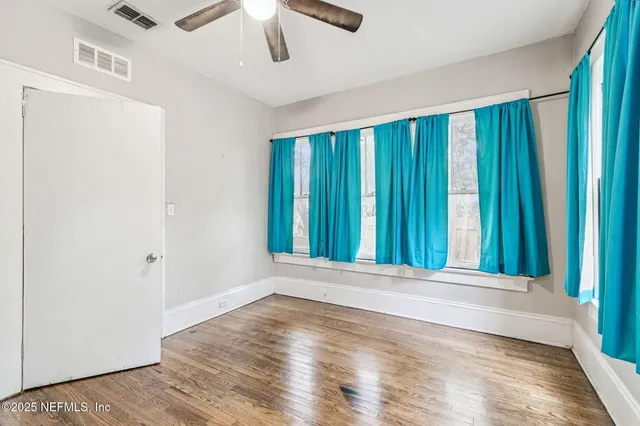 a white house that has tree in front of it