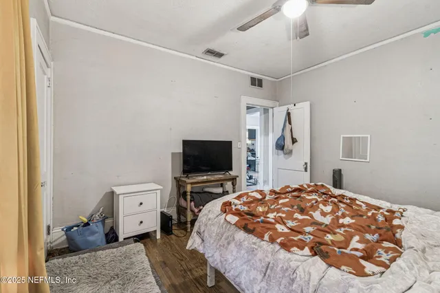 a view of a roof deck with couches and wooden fence