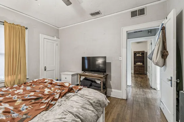 a view of a house with a yard and large trees