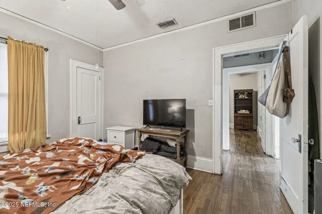 a view of a house with a yard and large trees