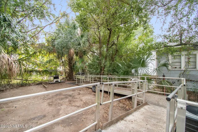 a backyard of a house with barbeque oven table and chairs