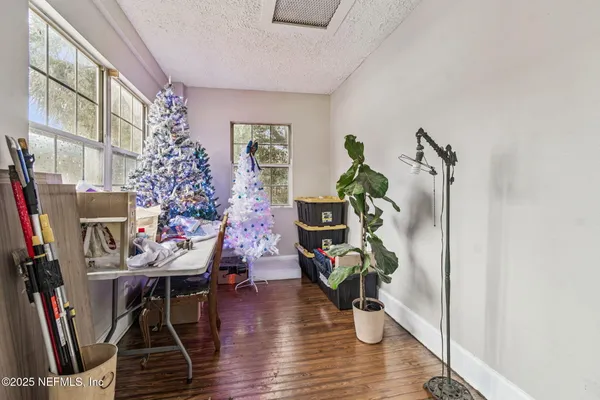 a living room with furniture a bookshelf and wooden floor