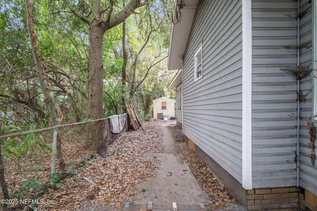 a backyard of a house with yard fire pit and outdoor seating