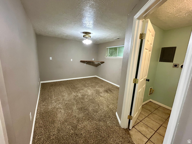 441 South 400 East Payson, UT 84651 - Photo 22 of 39 Carpeted room featuring a window with blinds, a wall-mounted shelf, and a ceiling light fixture