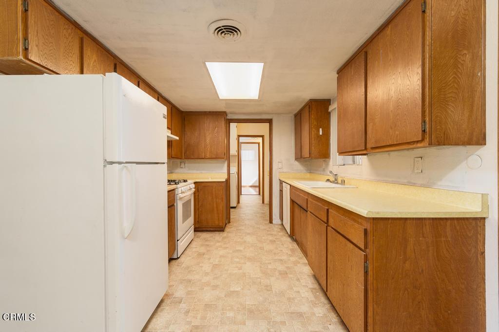 1060 Spring Street Oak View, CA 93022 - Photo 12 of 33 a kitchen with a sink refrigerator and cabinets