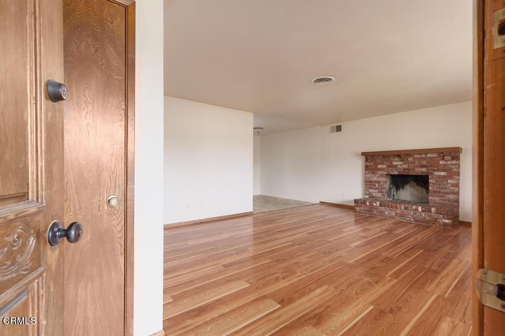 1060 Spring Street Oak View, CA 93022 - Photo 7 of 33 a view of a livingroom with wooden floor and a fireplace