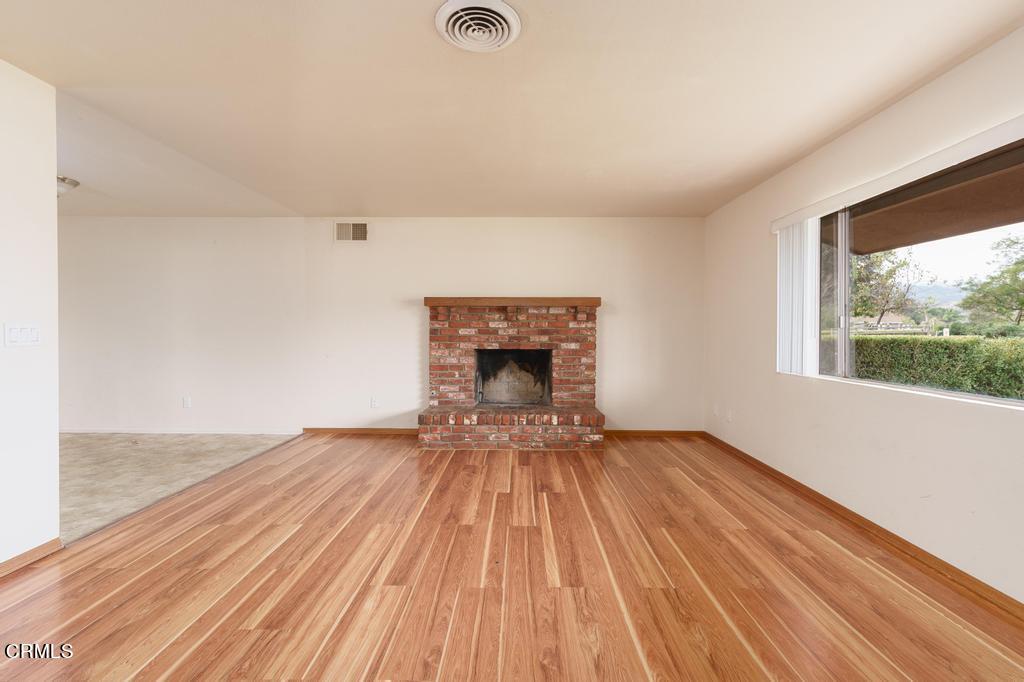 1060 Spring Street Oak View, CA 93022 - Photo 8 of 33 a view of empty room with wooden floor and fireplace