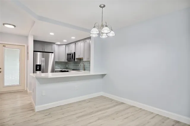 a view of a kitchen with electric appliances