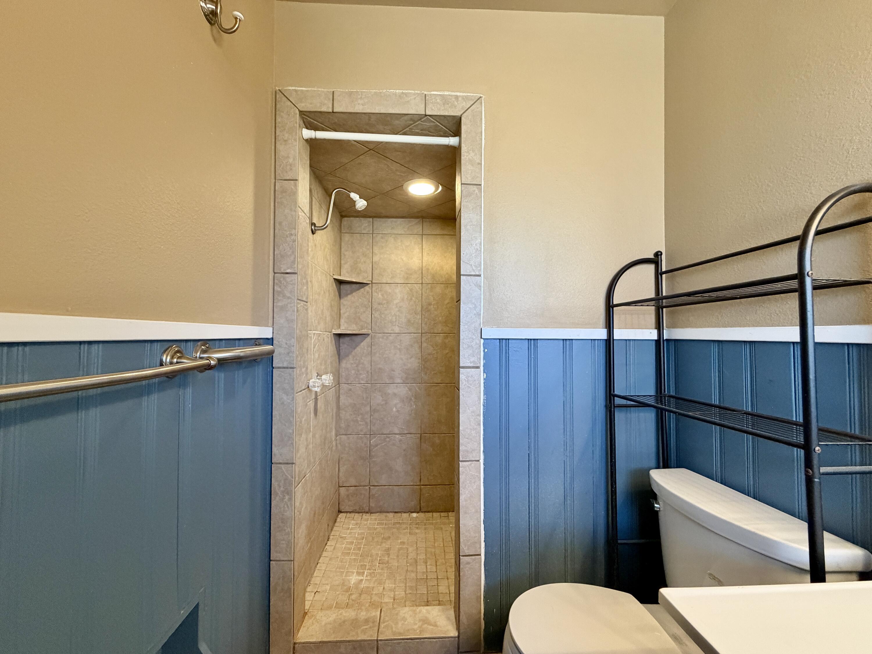 4401 28th Street Lubbock, TX 79410 - Photo 14 of 25 a bathroom with a toilet and a shower