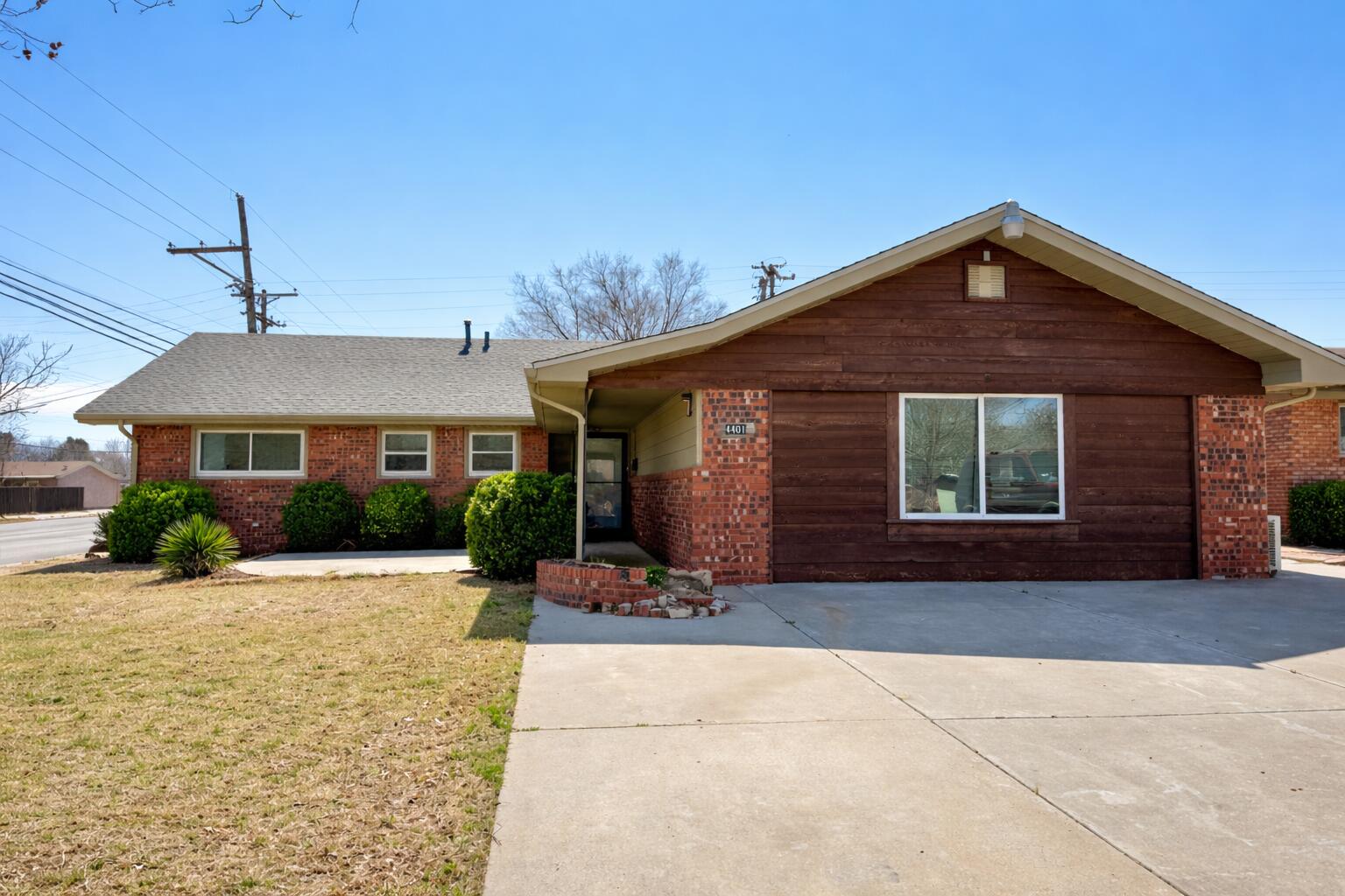 4401 28th Street Lubbock, TX 79410 - Photo 2 of 25 a front view of a house with yard and parking space