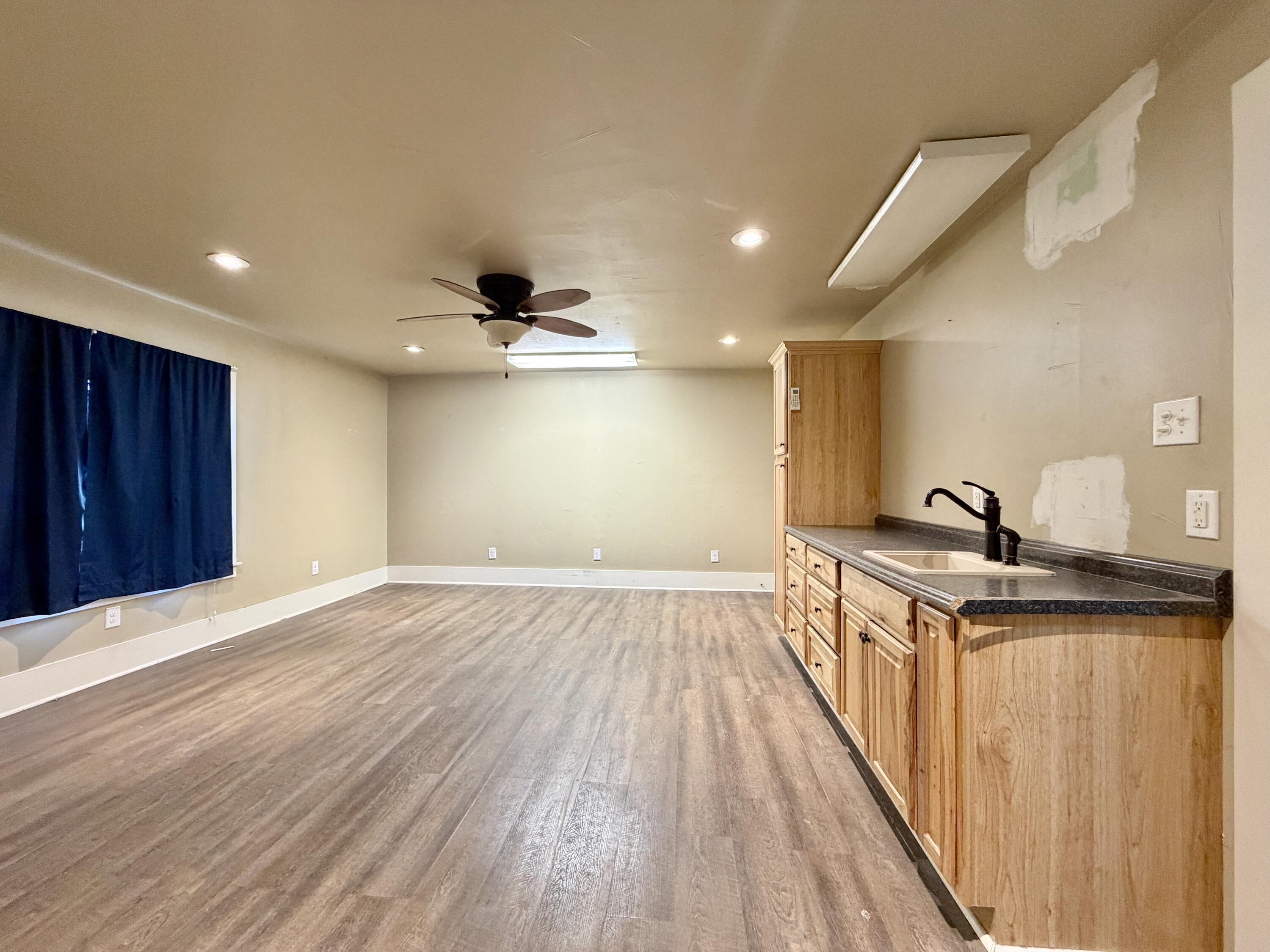 4401 28th Street Lubbock, TX 79410 - Photo 22 of 25 a view of a kitchen with a sink and wooden floor