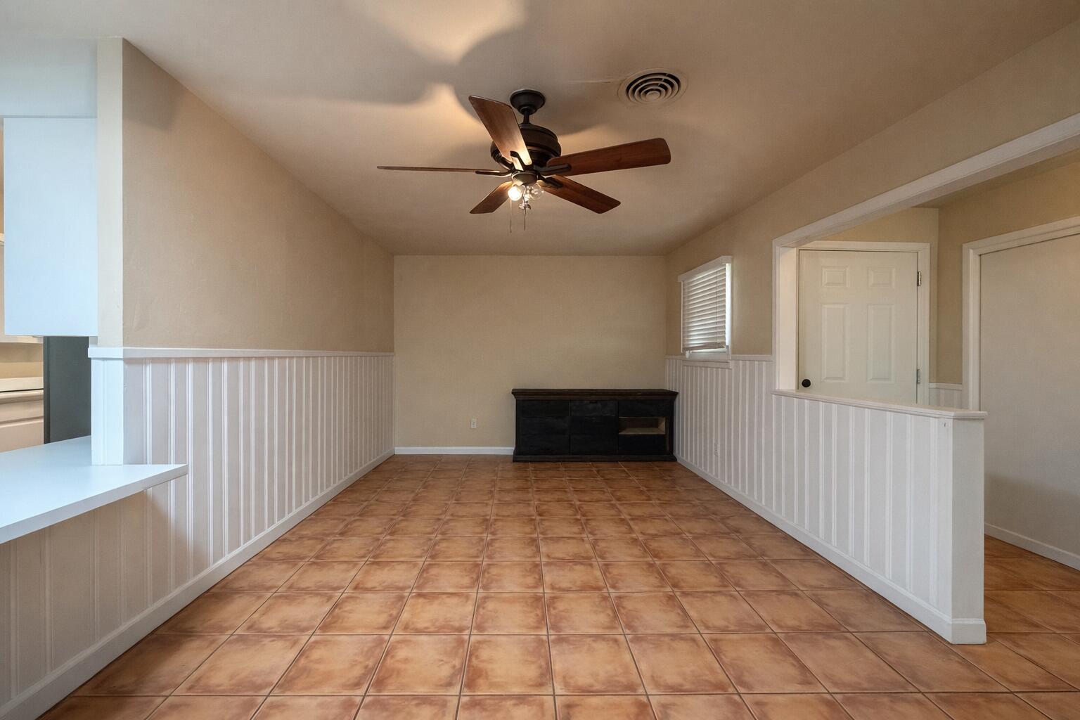 4401 28th Street Lubbock, TX 79410 - Photo 4 of 25 a view of a livingroom with a ceiling fan and window