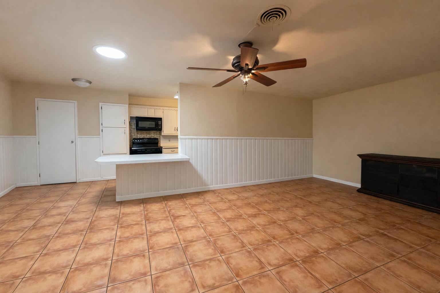 4401 28th Street Lubbock, TX 79410 - Photo 6 of 25 a view of a kitchen with a sink and a stove top oven
