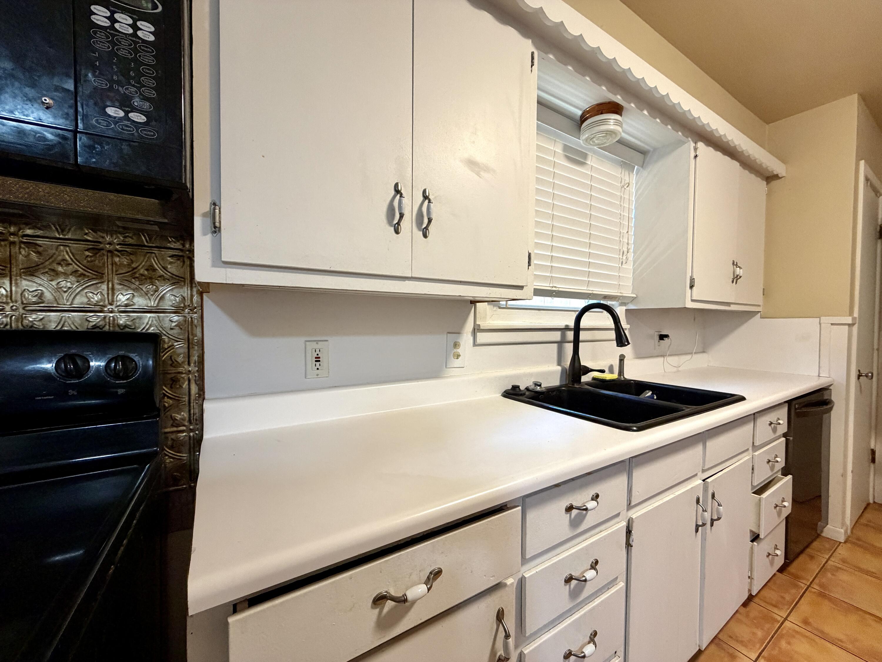 4401 28th Street Lubbock, TX 79410 - Photo 8 of 25 a kitchen with a sink and cabinets