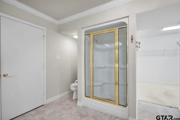 a bathroom with a glass shower door