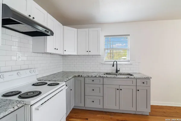 a kitchen with a sink cabinets and appliances