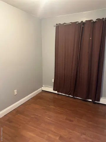a view of a closet with wooden floor