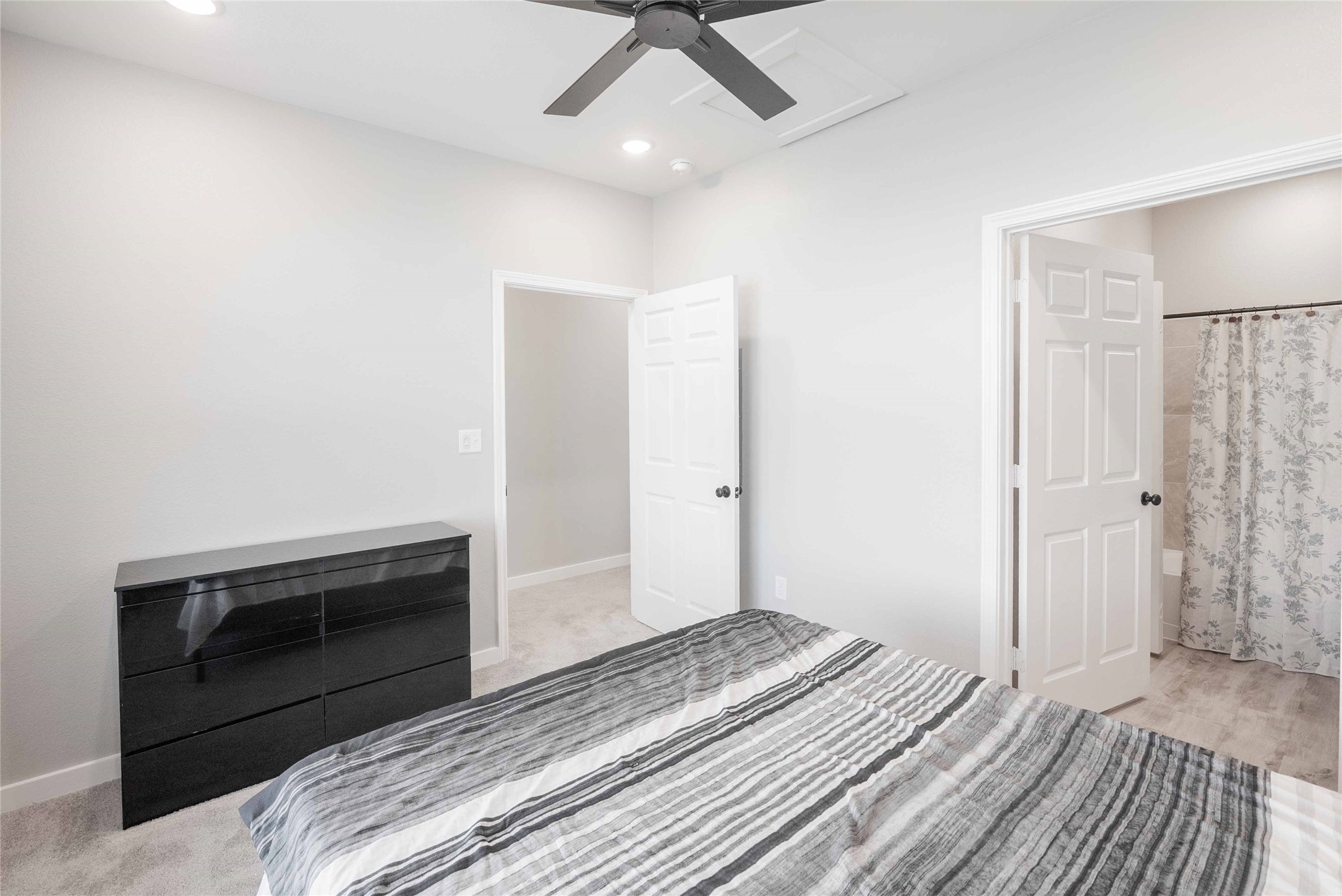 2101 Reinke Road, Unit 6104 Waller, TX 77484 - Photo 7 of 23 a bedroom with a bed and a ceiling fan
